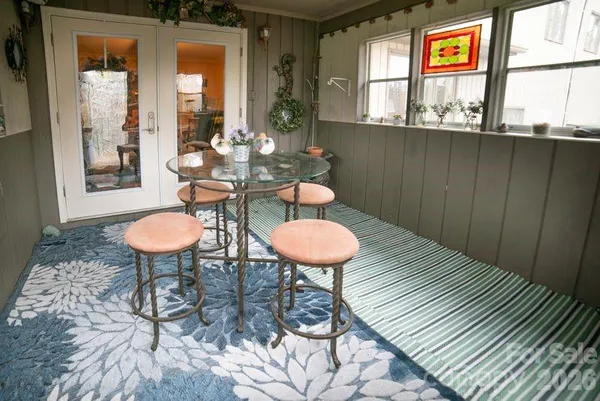 a backyard of a house with table and chairs