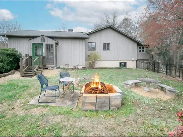 a backyard of a house with table and chairs