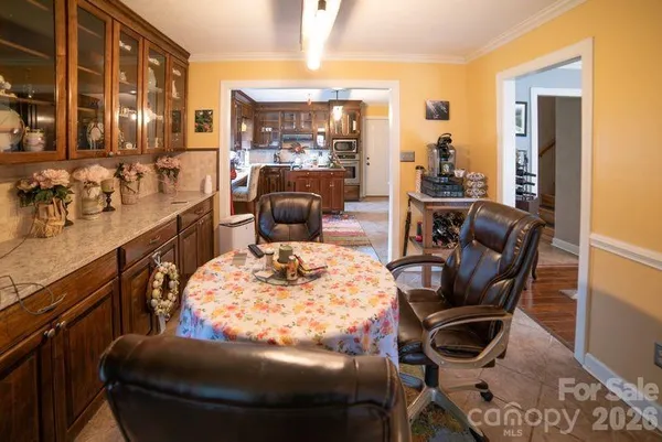 a large kitchen with kitchen island granite countertop wooden cabinets and stainless steel appliances