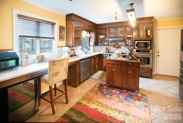 a view of a kitchen with appliances and a dining table