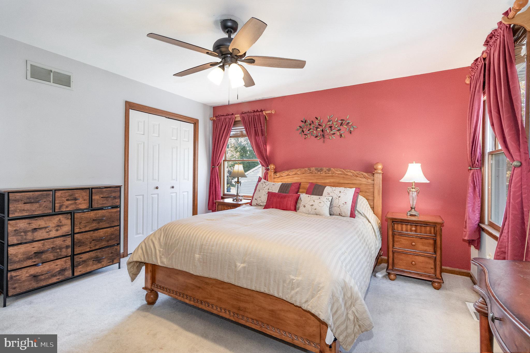 6418 Taunton Road Harrisburg, PA 17111 - Photo 14 of 39 a bedroom with a bed a dresser and a chandelier