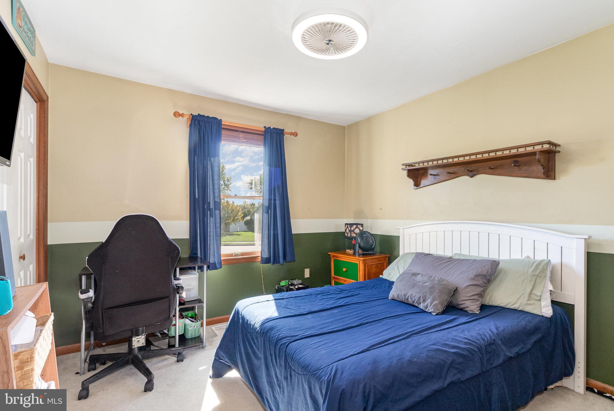 6418 Taunton Road Harrisburg, PA 17111 - Photo 17 of 39 a bedroom with a bed and a chair