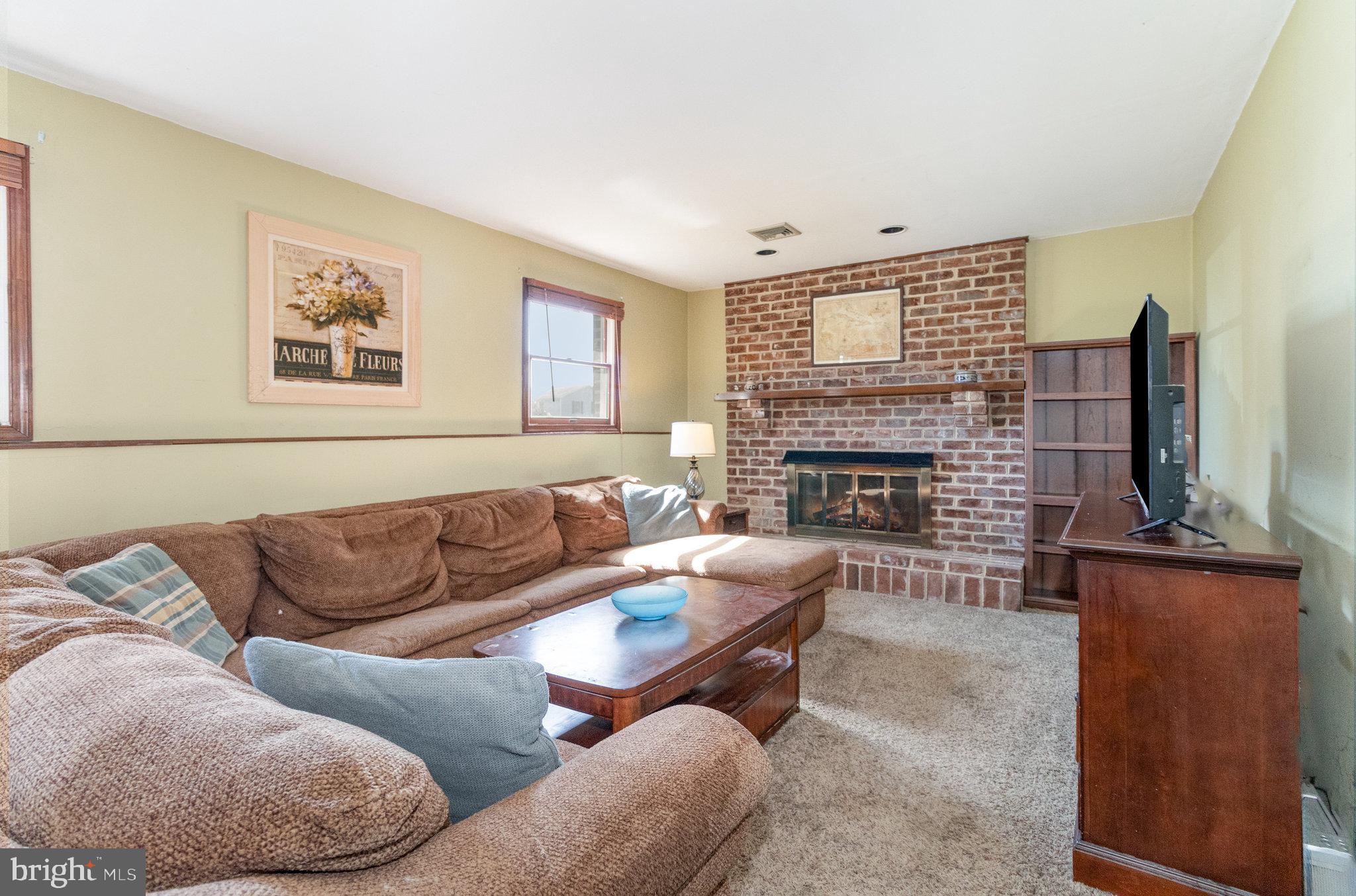 6418 Taunton Road Harrisburg, PA 17111 - Photo 19 of 39 a living room with furniture and a fireplace