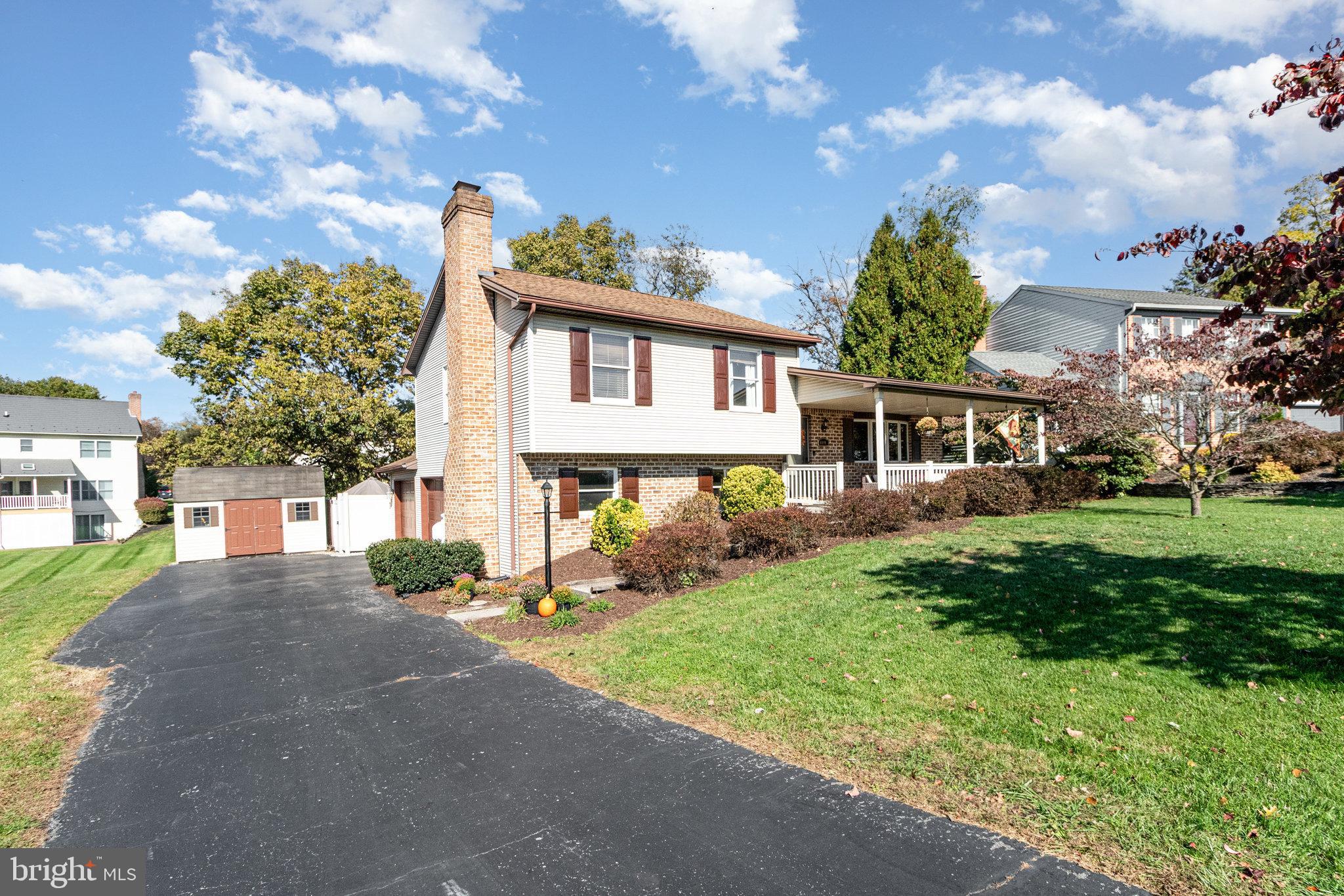 6418 Taunton Road Harrisburg, PA 17111 - Photo 2 of 39 a front view of a house with a yard and trees