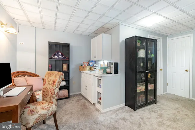 a bedroom with a bed and a tv on the wall