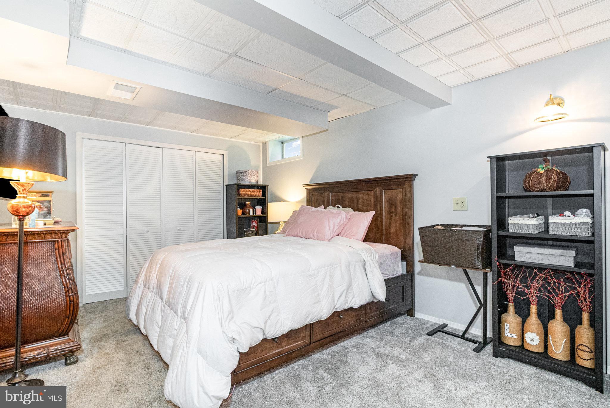 6418 Taunton Road Harrisburg, PA 17111 - Photo 23 of 39 a bedroom with a bed and a tv on the wall