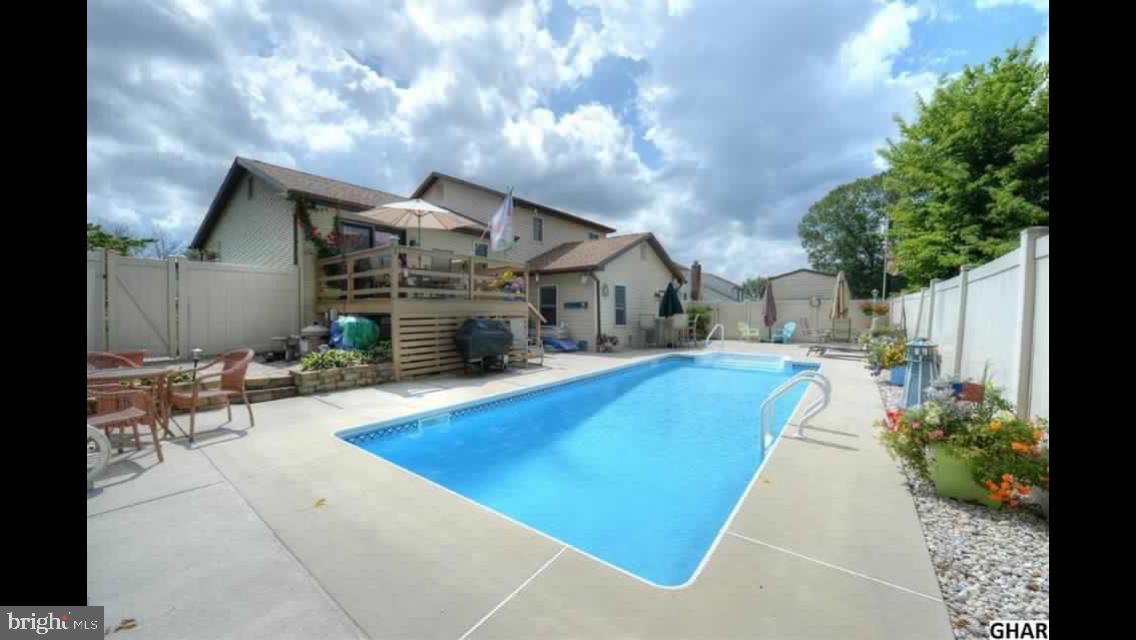 6418 Taunton Road Harrisburg, PA 17111 - Photo 27 of 39 a swimming pool with outdoor seating and yard in the back