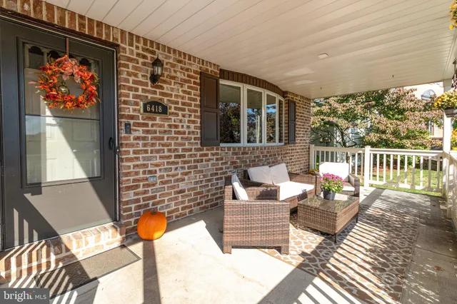 a living room with furniture a flat screen tv and a flat screen tv