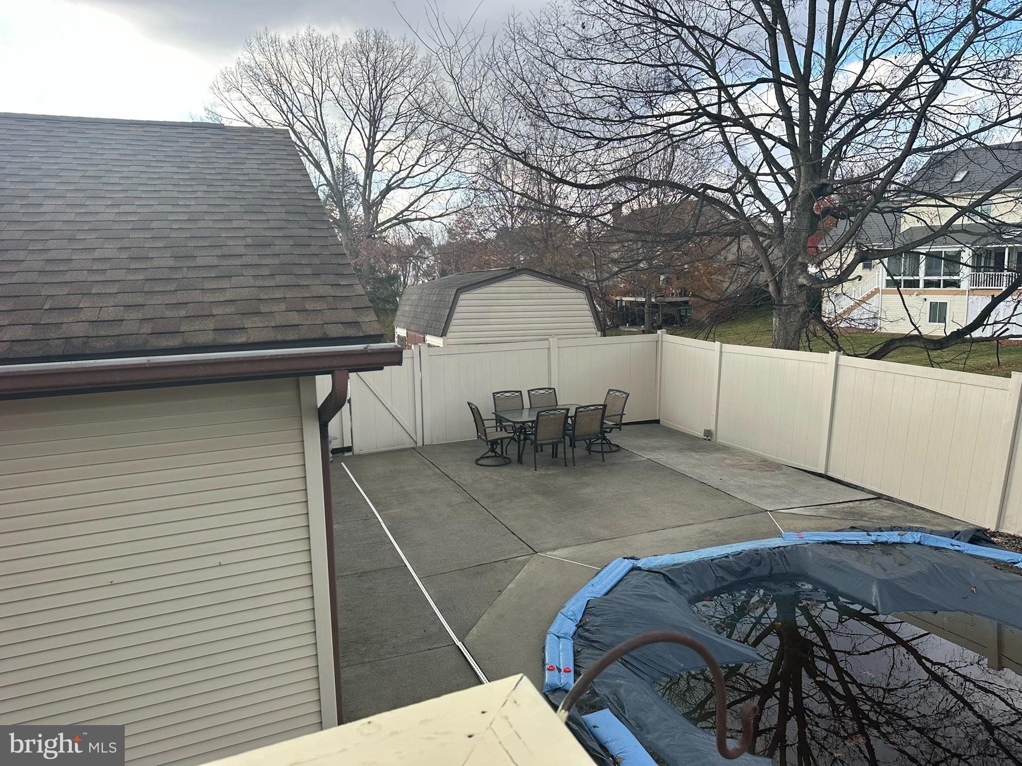 6418 Taunton Road Harrisburg, PA 17111 - Photo 31 of 39 a view of a backyard with a table and chairs under an umbrella