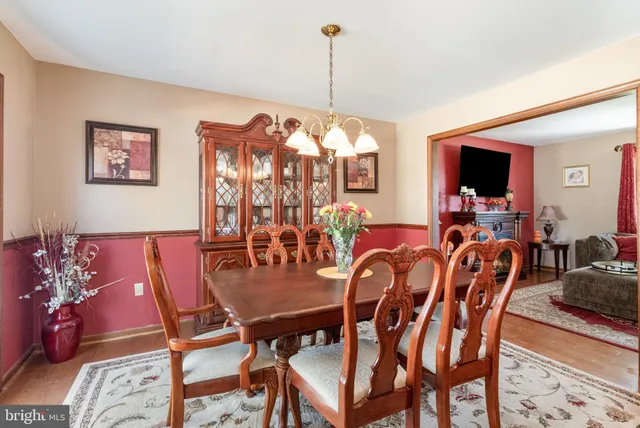 a kitchen with refrigerator a sink and chairs