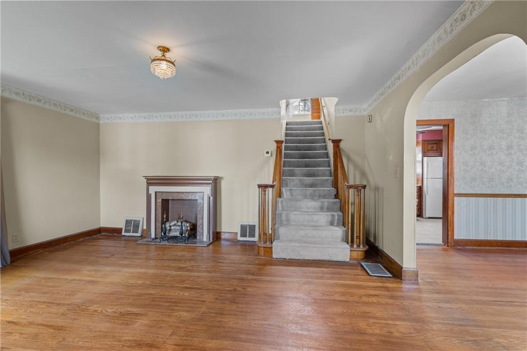 535 Oak Street Sharpsville, PA 16150 - Photo 2 of 19 a view of a livingroom with wooden floor and a fireplace