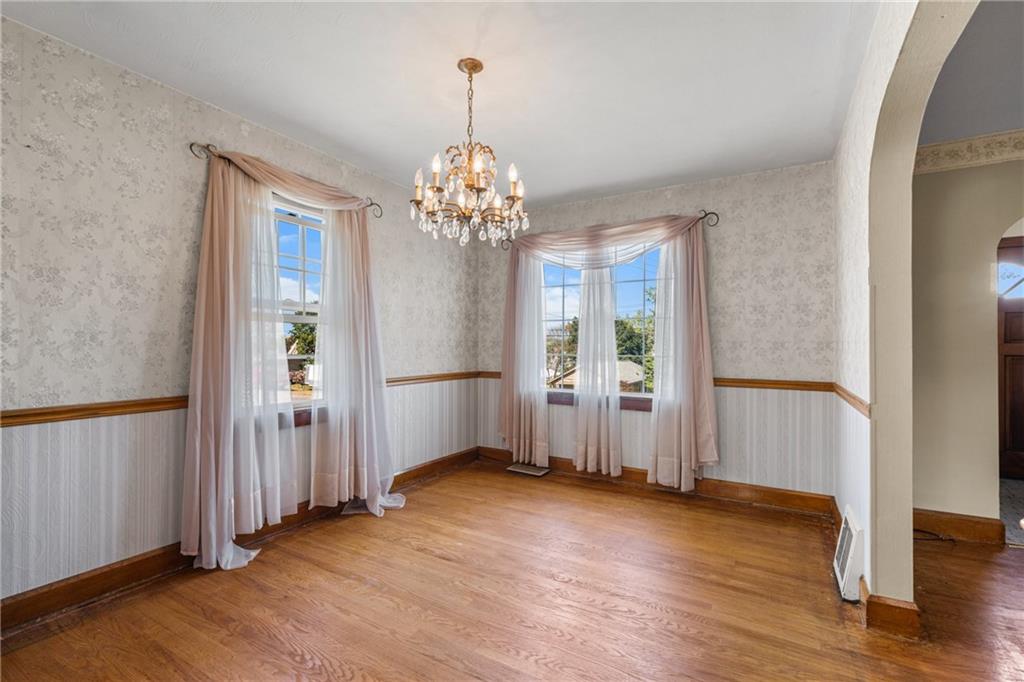 535 Oak Street Sharpsville, PA 16150 - Photo 6 of 19 an empty room with wooden floor chandelier and windows