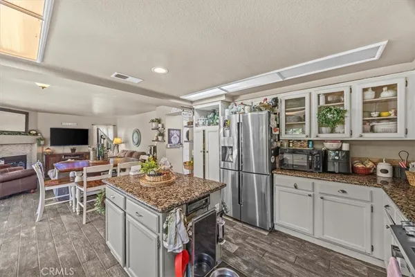 a kitchen with stainless steel appliances granite countertop a stove refrigerator and cabinets