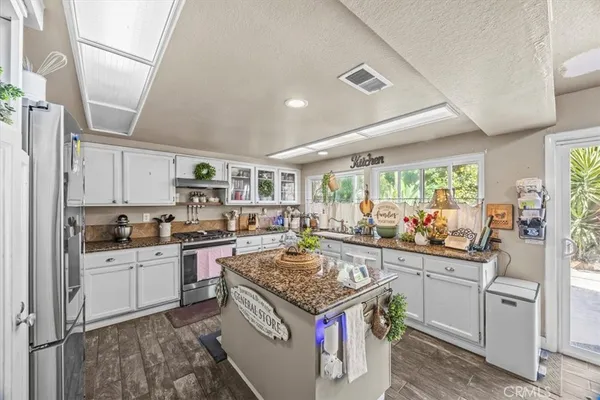 a kitchen with a stove sink and cabinets
