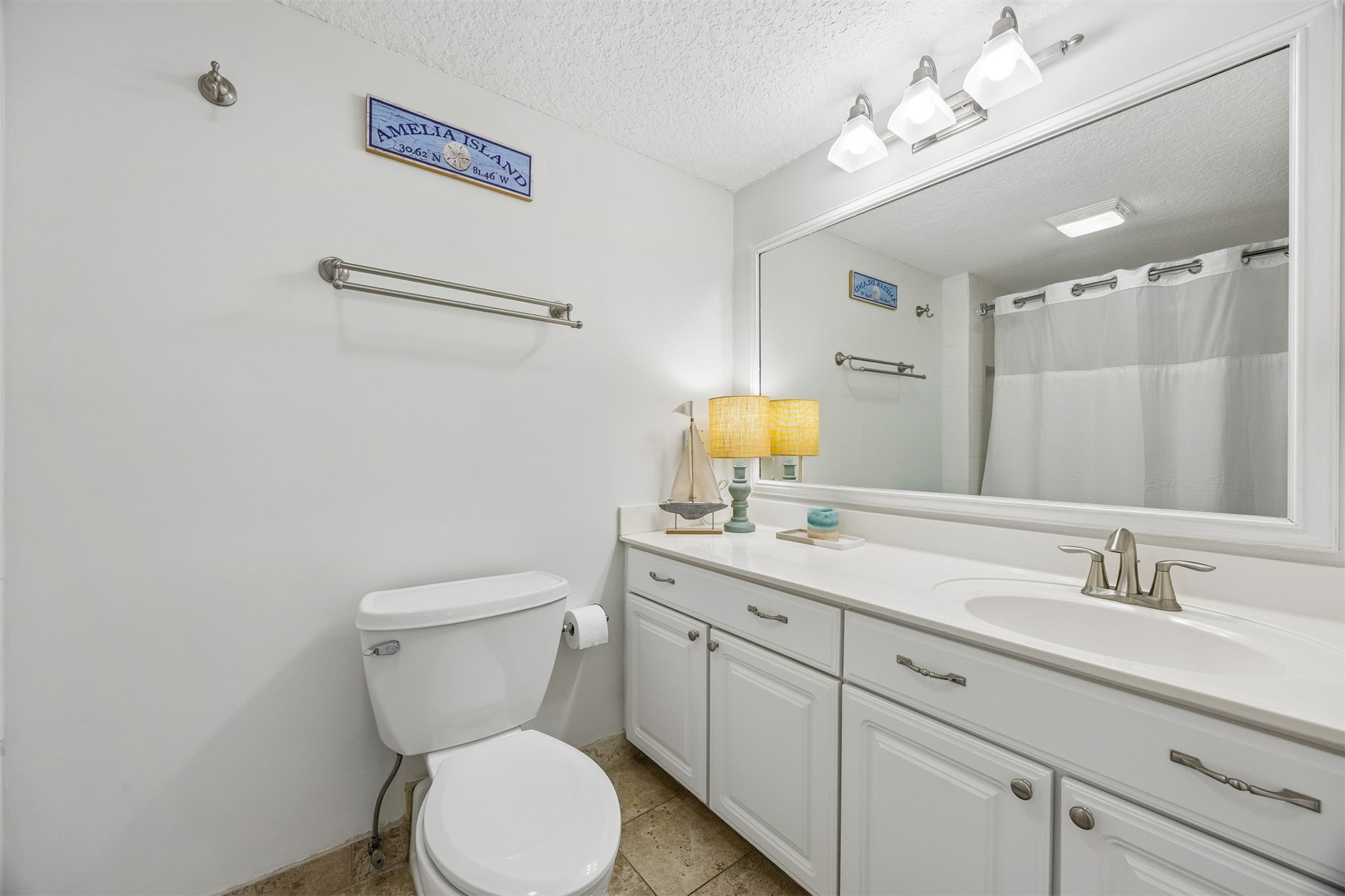 1119 Beach Walker Road, Unit 1119 Fernandina Beach, FL 32034 - Photo 13 of 32 a bathroom with a toilet sink and mirror