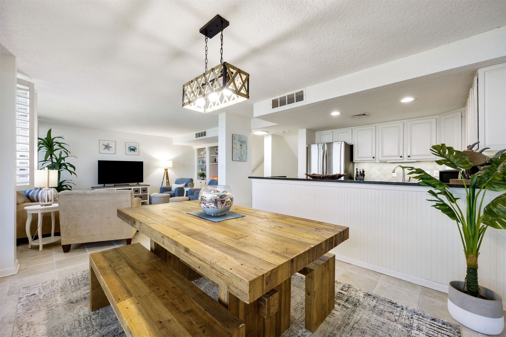 1119 Beach Walker Road, Unit 1119 Fernandina Beach, FL 32034 - Photo 2 of 32 a view of a dining room and livingroom with furniture wooden floor a chandelier