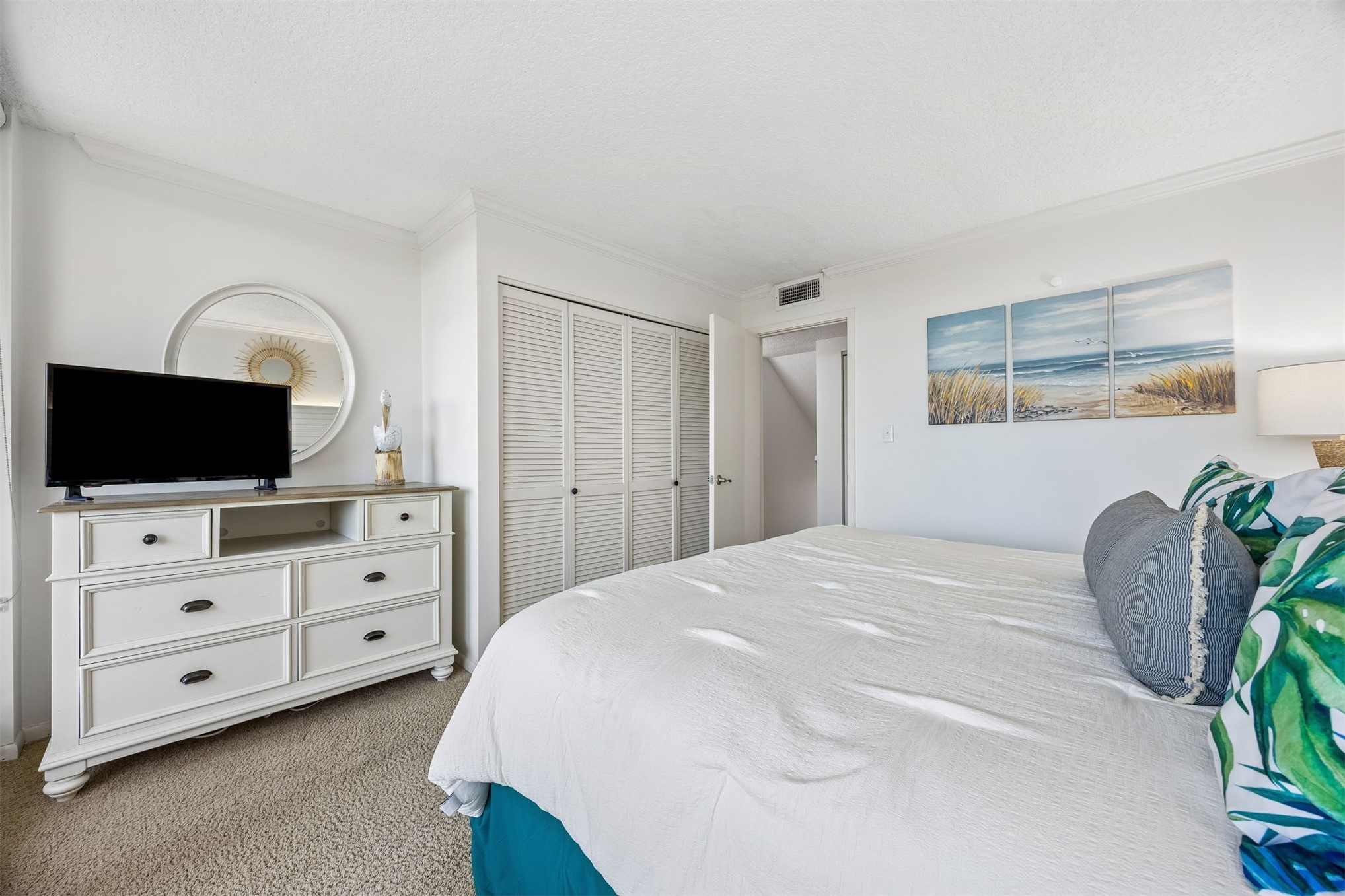 1119 Beach Walker Road, Unit 1119 Fernandina Beach, FL 32034 - Photo 6 of 32 a spacious bedroom with a bed and a flat screen tv