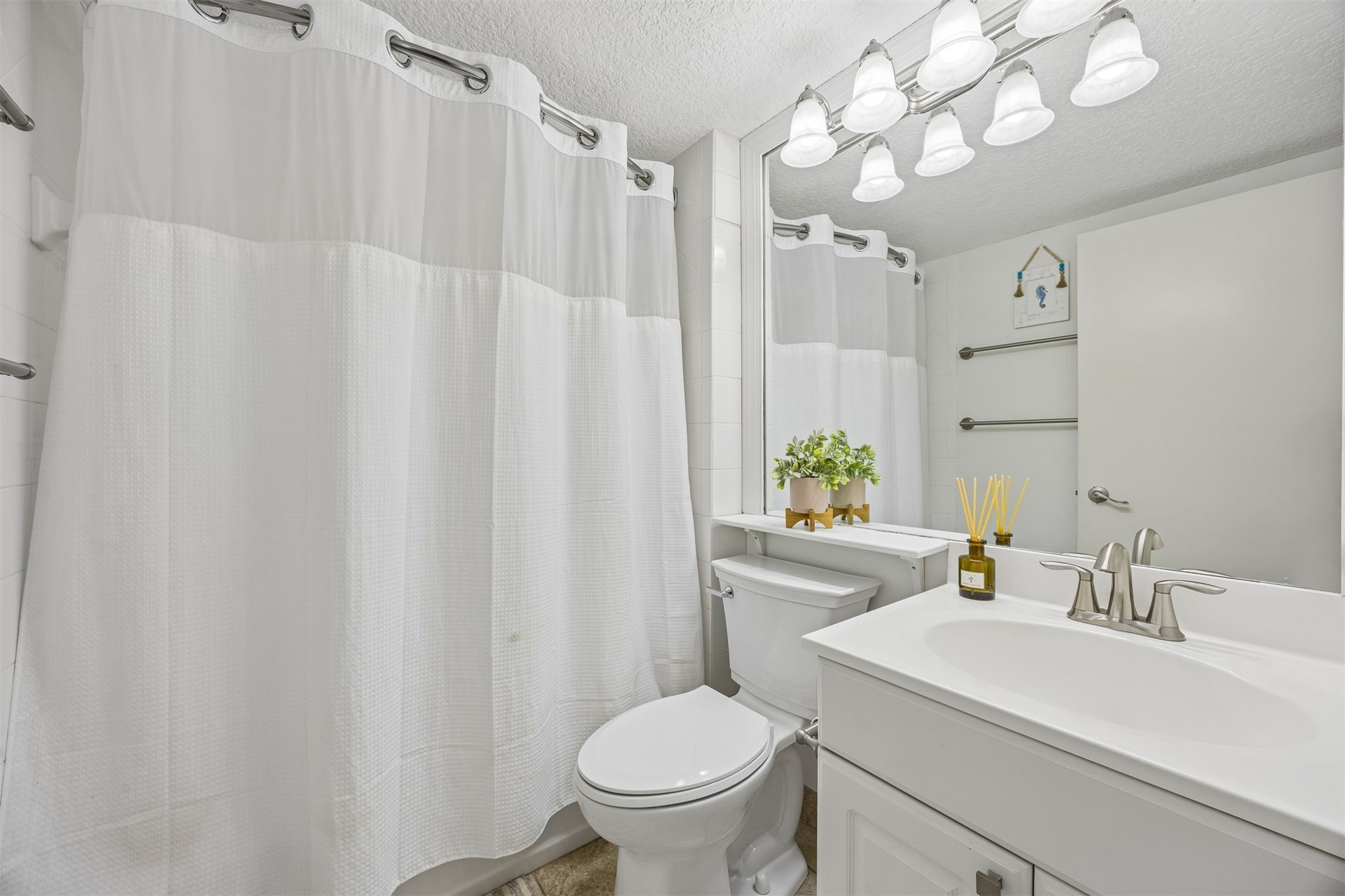 1119 Beach Walker Road, Unit 1119 Fernandina Beach, FL 32034 - Photo 9 of 32 a bathroom with a sink a toilet and a mirror