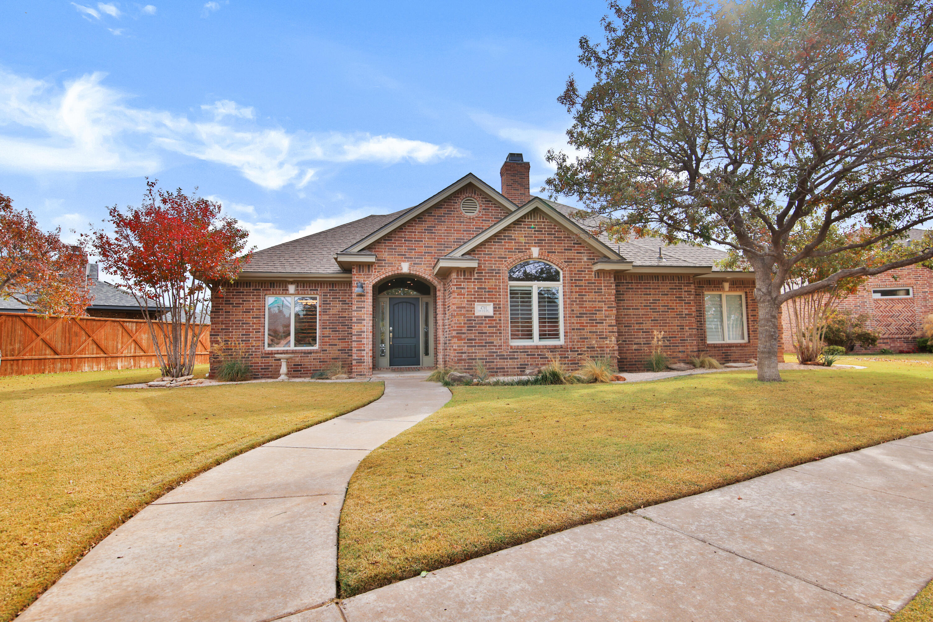 4701 109th Place Lubbock, TX 79424 - Photo 1 of 42 a front view of a house with a yard and trees