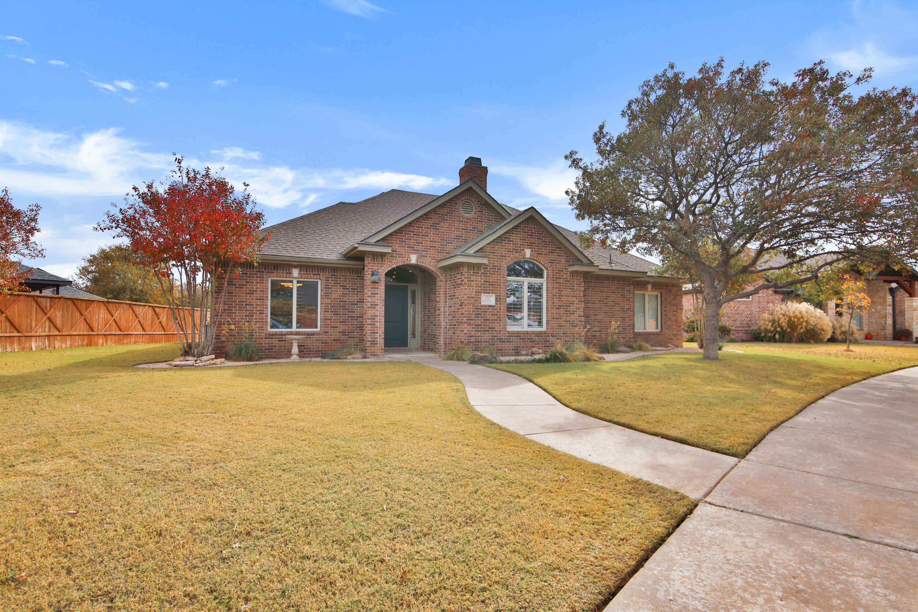 4701 109th Place Lubbock, TX 79424 - Photo 2 of 42 a front view of a house with yard and trees