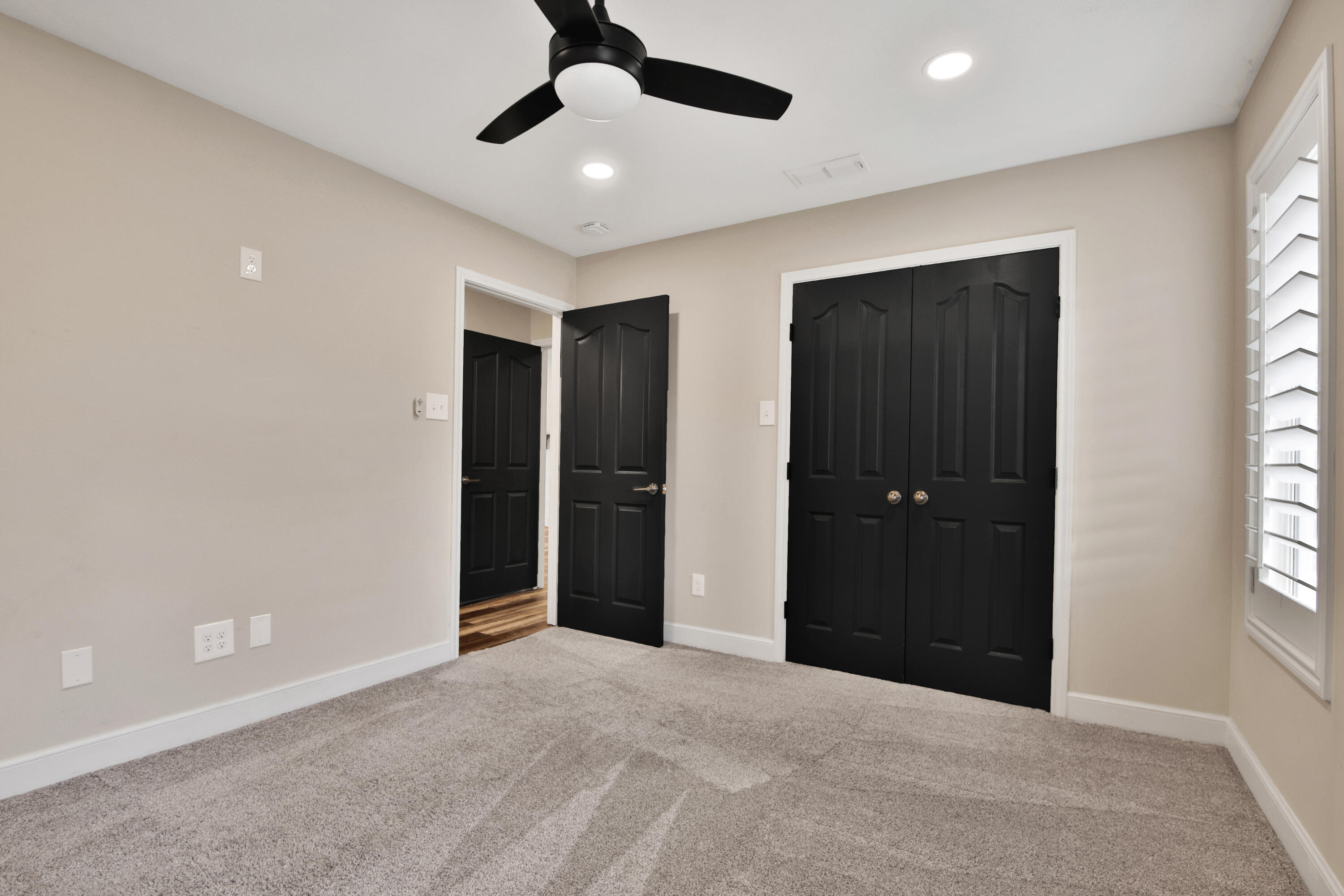 4701 109th Place Lubbock, TX 79424 - Photo 31 of 42 a view of an empty room with windows and chandelier fan