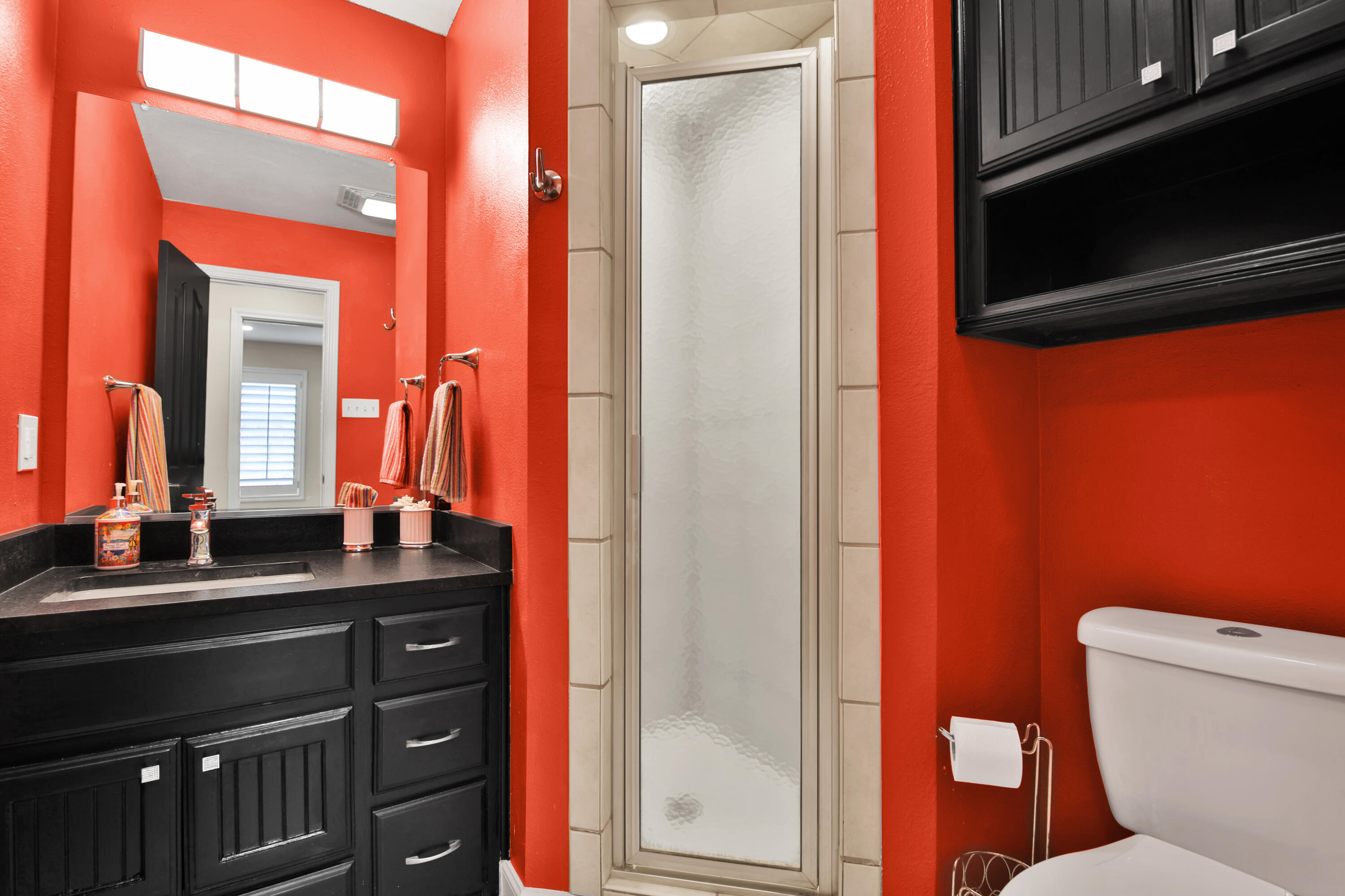 4701 109th Place Lubbock, TX 79424 - Photo 32 of 42 a bathroom with a sink a toilet a mirror and shower