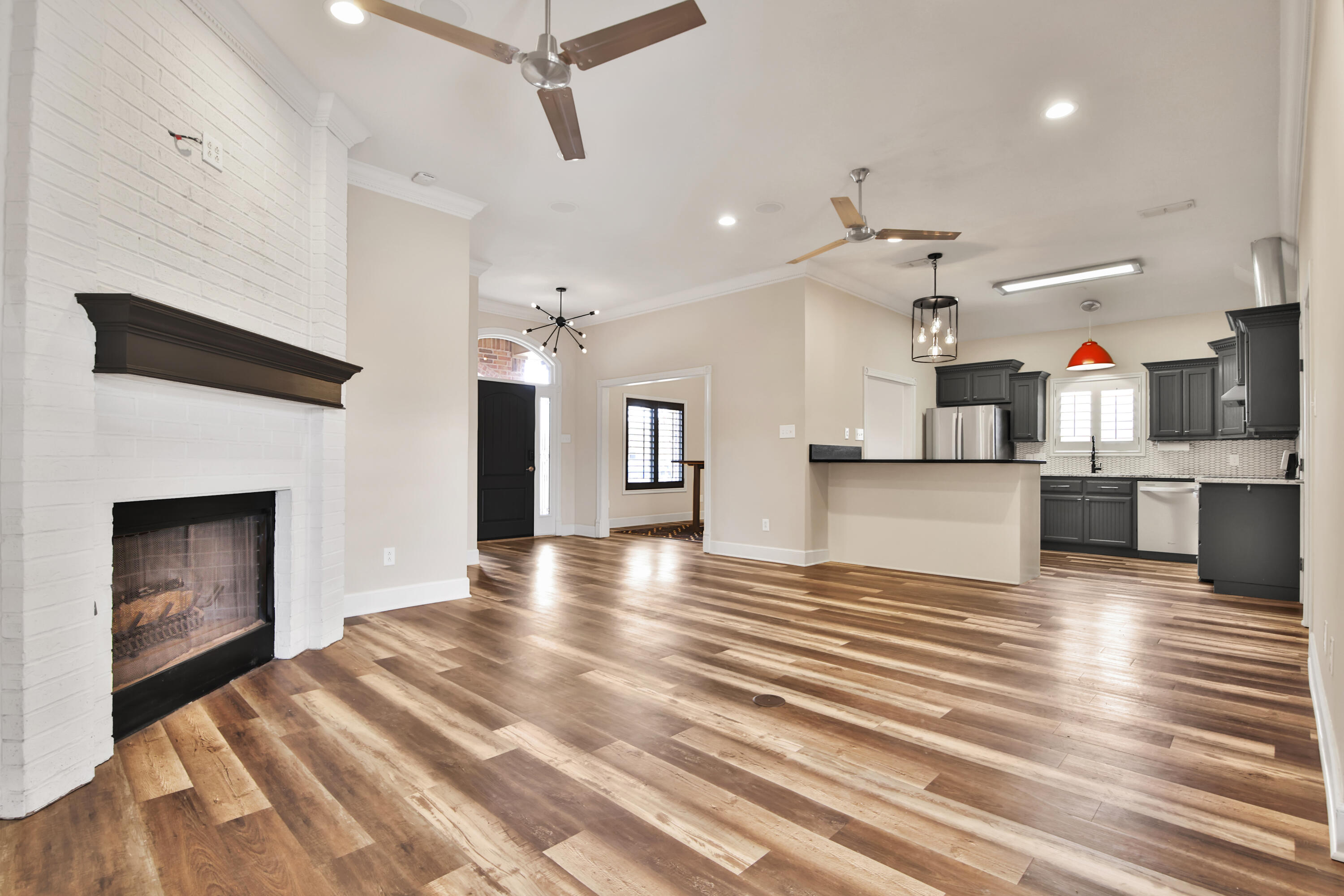 4701 109th Place Lubbock, TX 79424 - Photo 5 of 42 an empty room with wooden floor a fireplace and windows