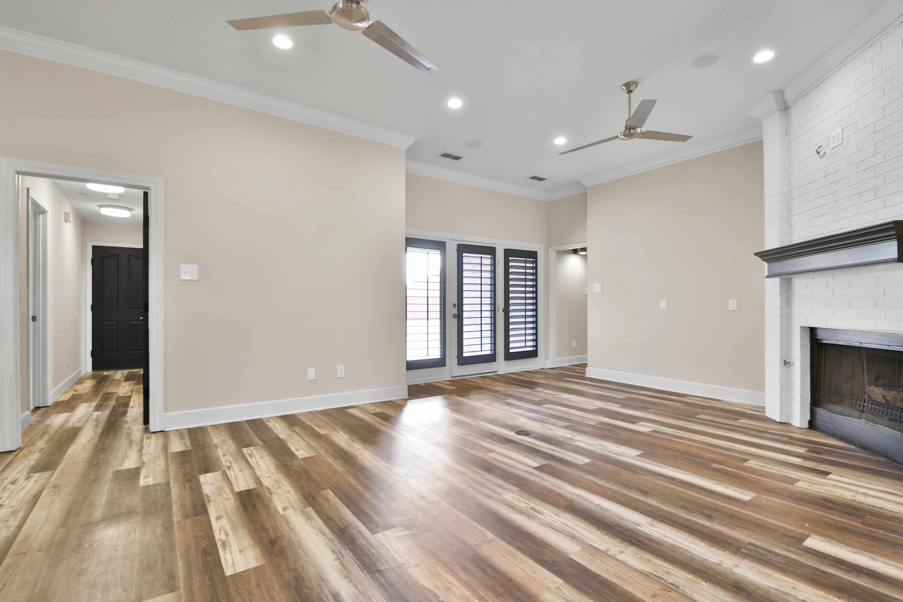 4701 109th Place Lubbock, TX 79424 - Photo 6 of 42 a view of an empty room with wooden floor fireplace and a window