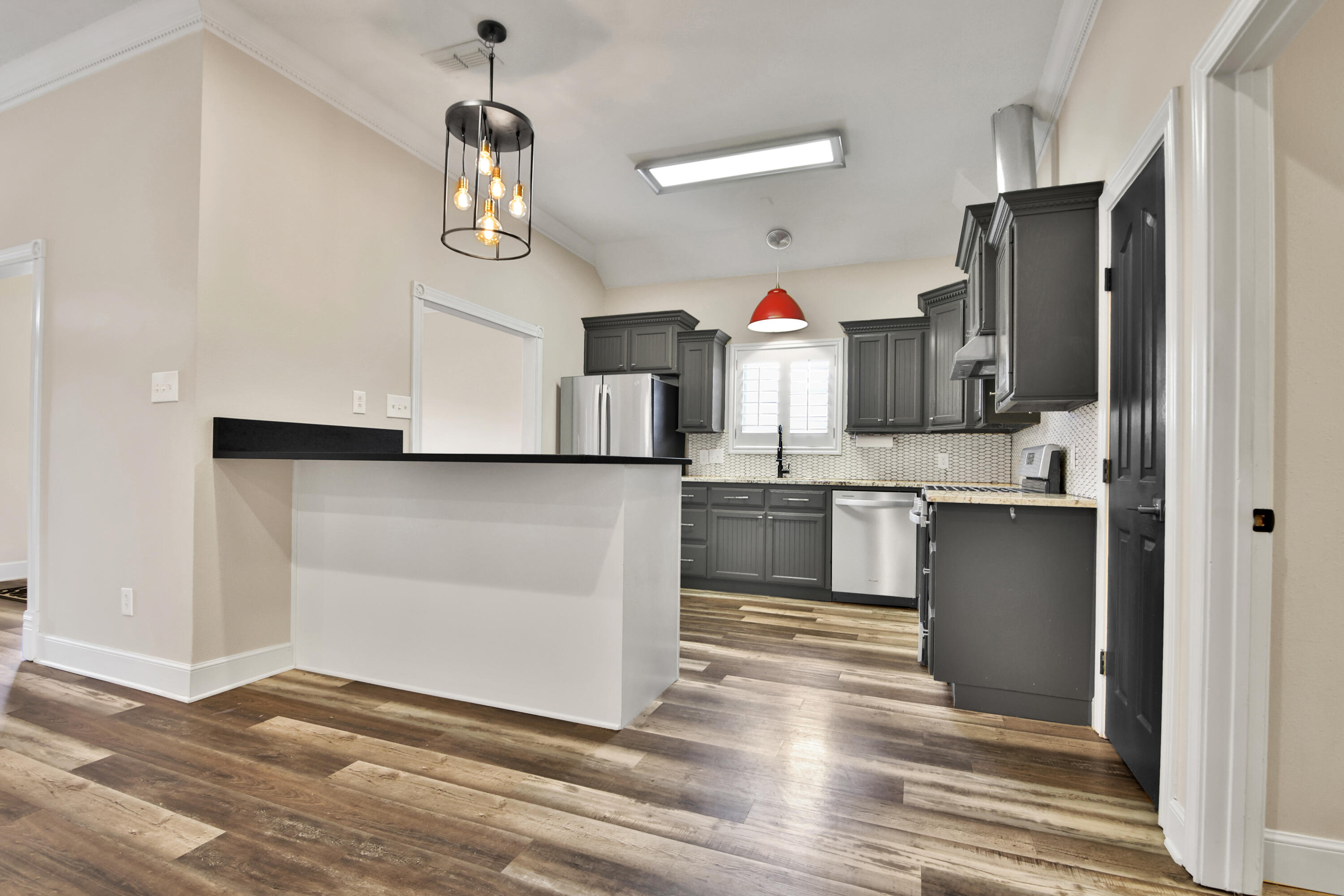 4701 109th Place Lubbock, TX 79424 - Photo 7 of 42 a kitchen with granite countertop a refrigerator and a sink