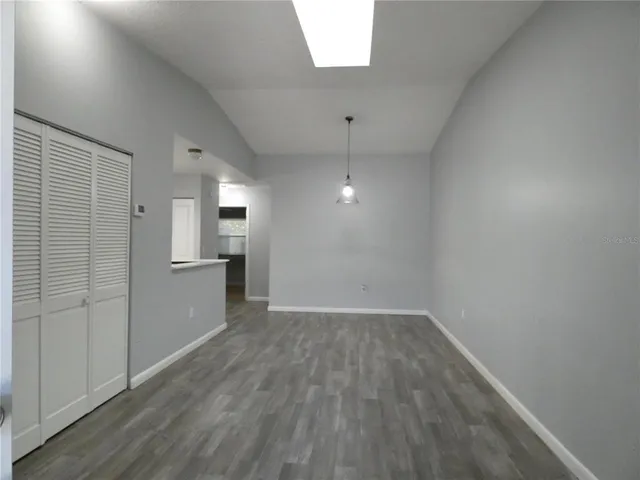 a view of a kitchen with a sink and wooden floor
