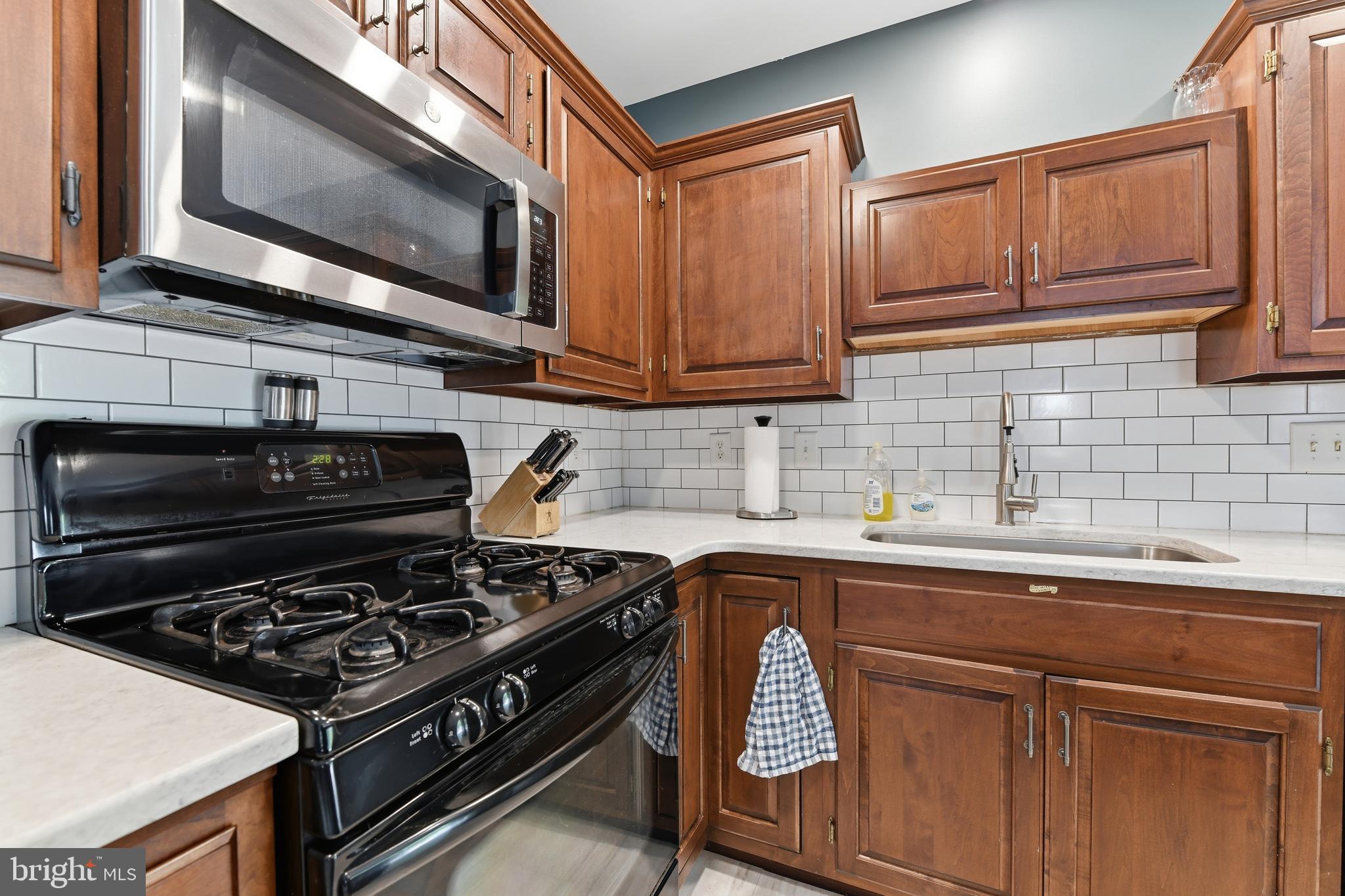 3121 South Wagner Circle Sinking Spring, PA 19608 - Photo 5 of 30 a kitchen with stainless steel appliances granite countertop a stove and a sink