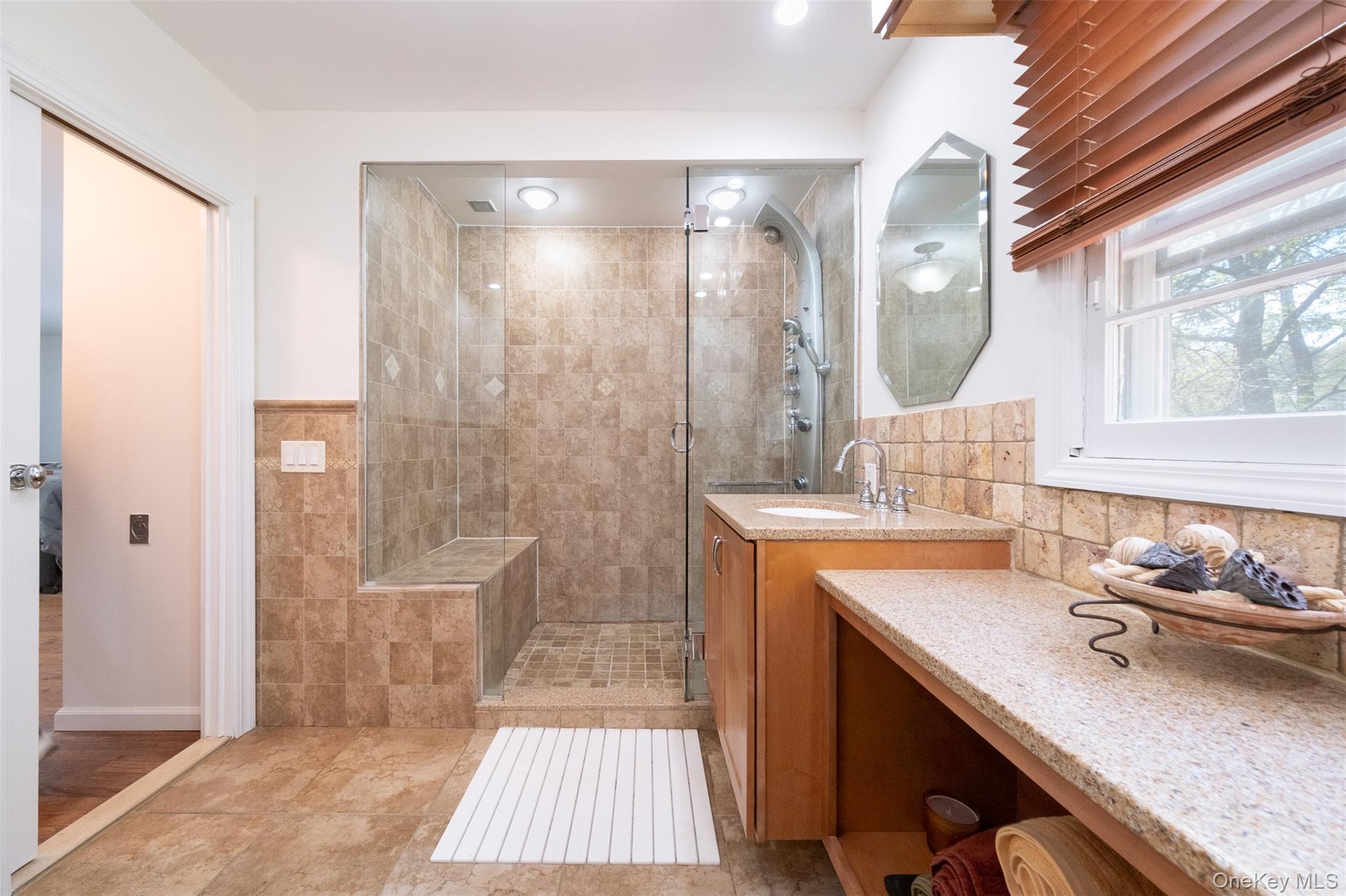 24 Sheldrake Place New Rochelle, NY 10804 - Photo 15 of 26 Full bathroom with a shower stall, vanity, and tile walls