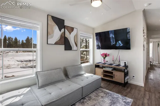 a living room with furniture and a flat screen tv