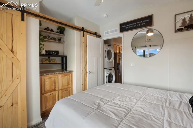 a bedroom with a bed and a mirror