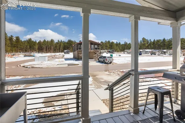 a view of a balcony with a table and chairs