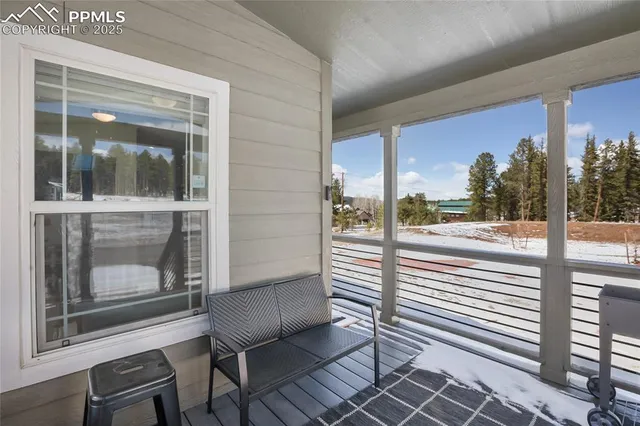 a view of a porch with a table and chairs