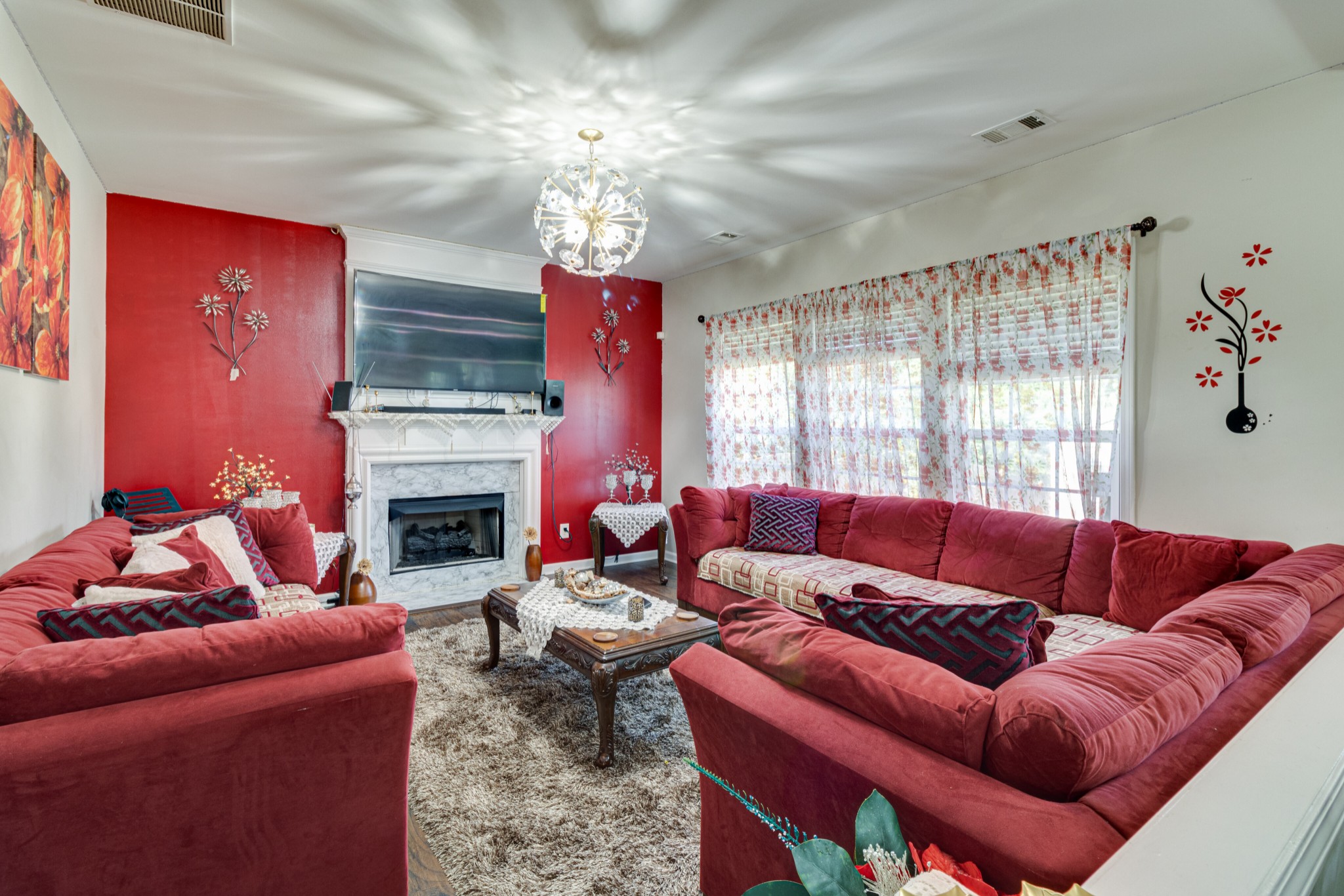 1696 Eagle Trace Drive Mount Juliet, TN 37122 - Photo 10 of 28 a living room with furniture a fireplace and a chandelier