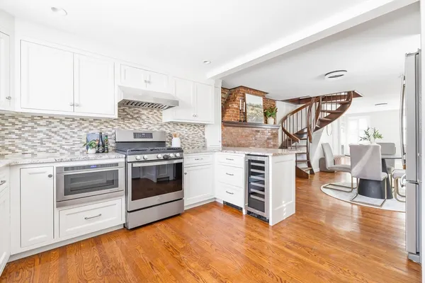 a kitchen with stainless steel appliances a stove top oven and cabinets
