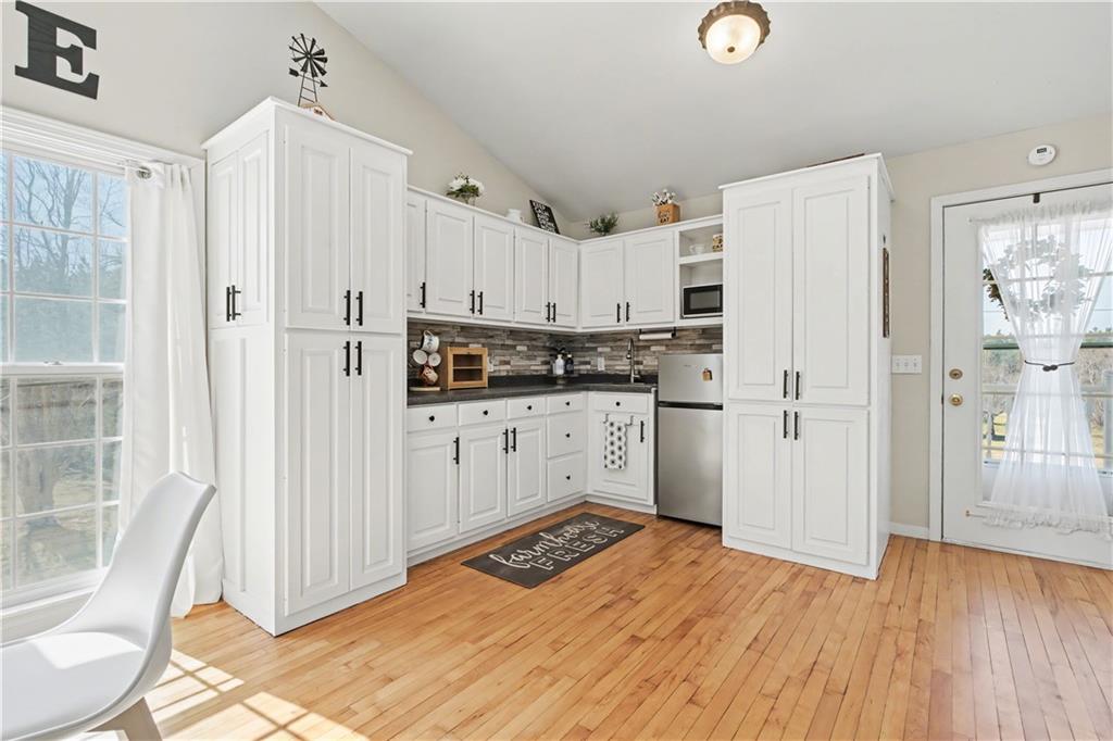 1833 Tom Odum Road Vidalia, GA 30474 - Photo 47 of 59 a kitchen with granite countertop a refrigerator sink and white cabinets
