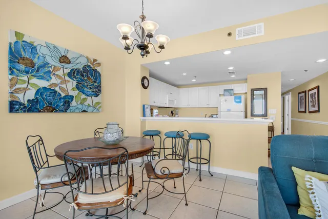 a view of a dining room with furniture and chandelier