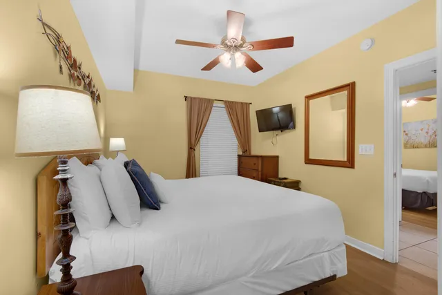 a bedroom with a bed and a painting on the wall