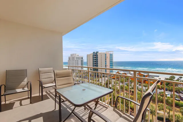 a balcony with table and chairs