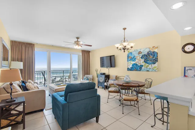 a living room with furniture flowerpot and a chandelier