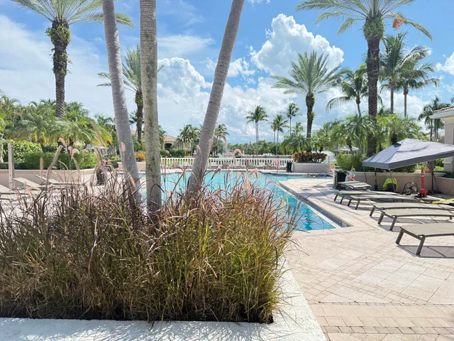 a living room with furniture windows and a chandelier