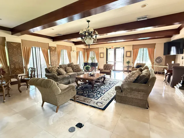a view of livingroom with furniture and large window