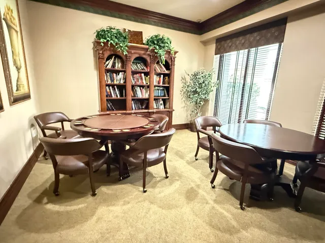 a room with pool table and windows