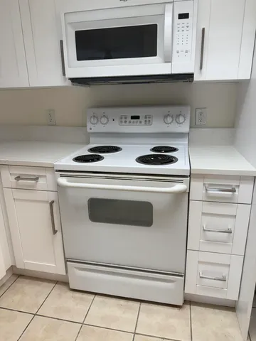 a stove top oven sitting inside of a kitchen
