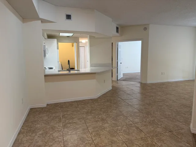 a view of a kitchen with white cabinets