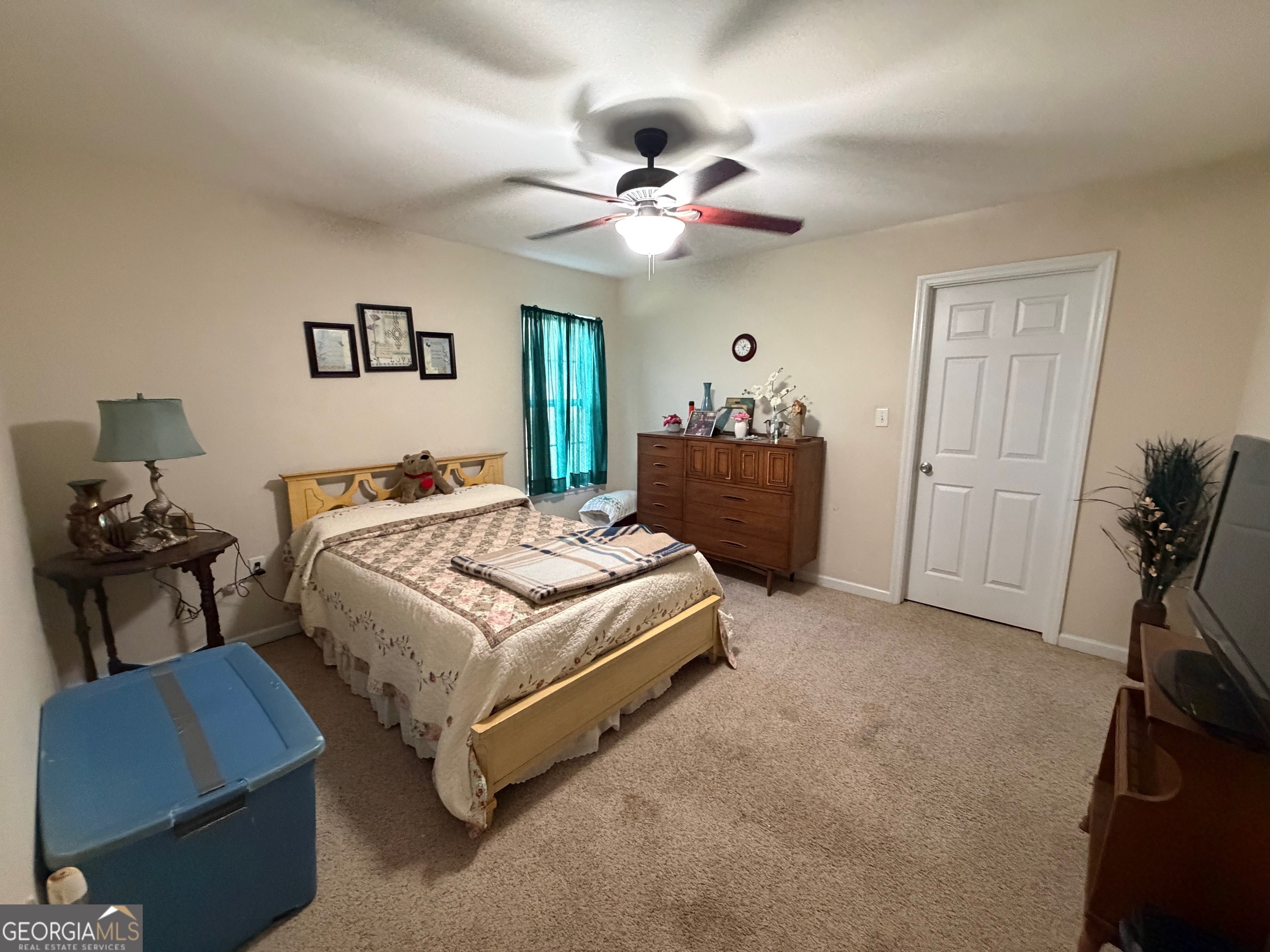 257 Mountain Laurel Road Nashville, GA 31639 - Photo 19 of 41 a bedroom with a bed and a chandelier