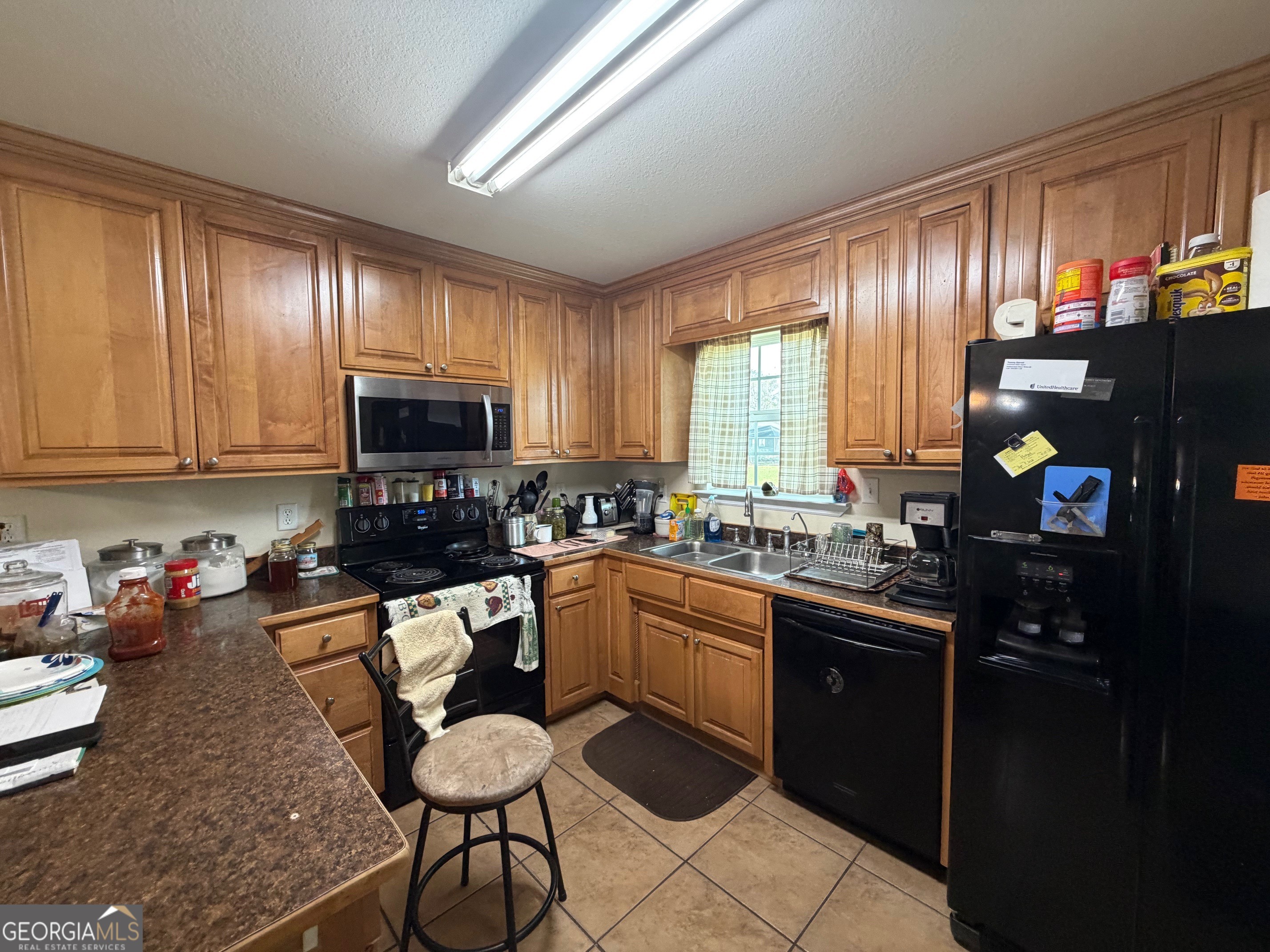 257 Mountain Laurel Road Nashville, GA 31639 - Photo 33 of 41 a kitchen with granite countertop sink cabinets and stainless steel appliances